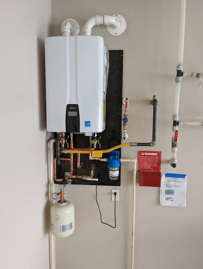 Professional plumber installing copper piping in a Akron home